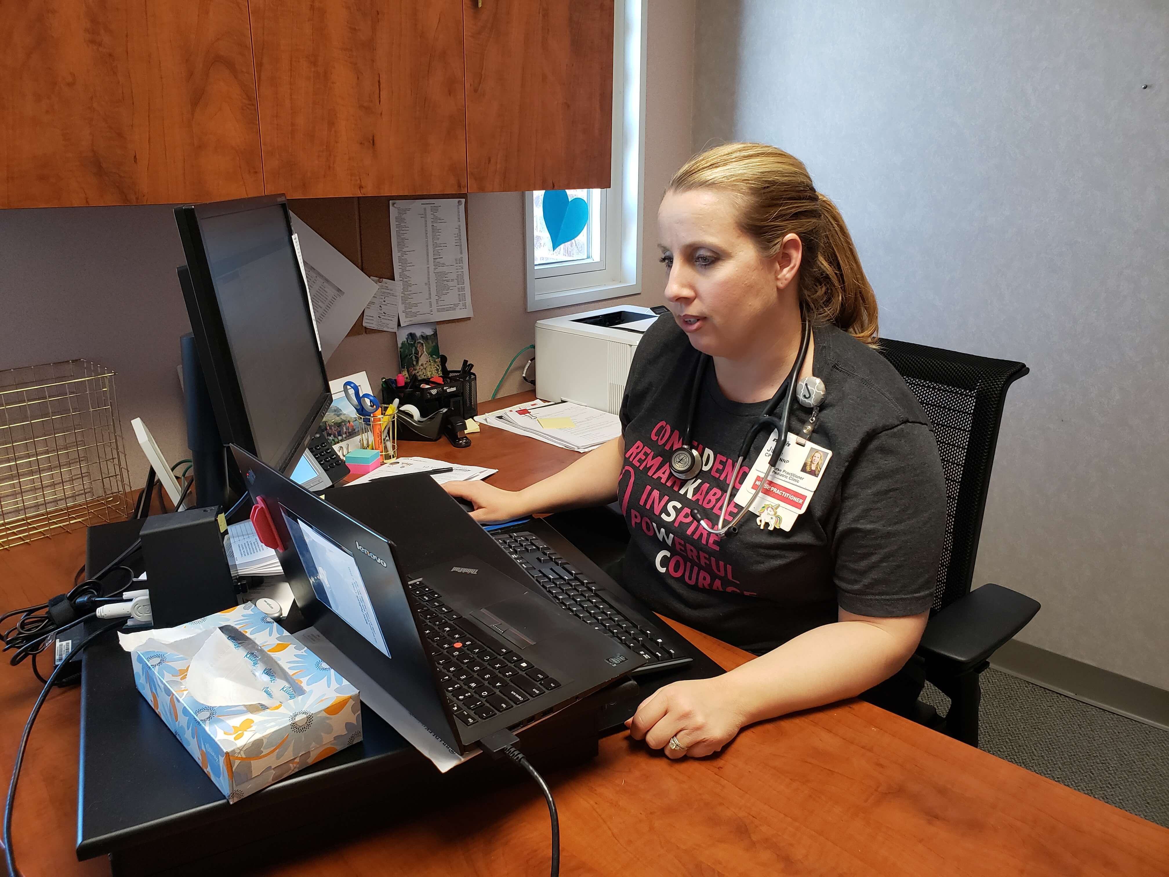 woman at a desk with computers 