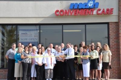 doctors and staff cutting a ribbon